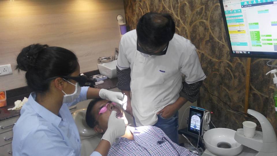Dentist using laser